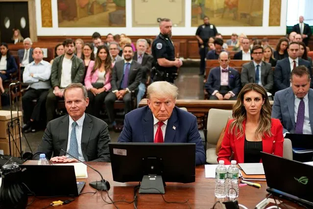Former President Donald Trump, center, sits in the courtroom with is legal team before the continuation of his civil business fraud trial at New York Supreme Court, Tuesday, October 3, 2023, in New York. Trump is in a New York court for the second day of his civil business fraud trial. A day after fiery opening statements, lawyers in the case are moving Tuesday to the plodding task of going through years' worth of Trump's financial documents. (Photo by Seth Wenig/Pool via AP Photo)