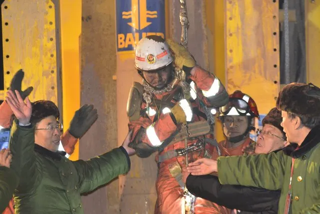 A trapped worker is lifted from a collapsed gypsum mine after 36 days of rescue, in Pingyi, Shandong province, January 29, 2016. Rescuers lifted four miners out of a collapsed gypsum mine in east China's Shandong Province on Friday, 36 days after a cave-in trapped them underground. (Photo by Reuters/China Daily)