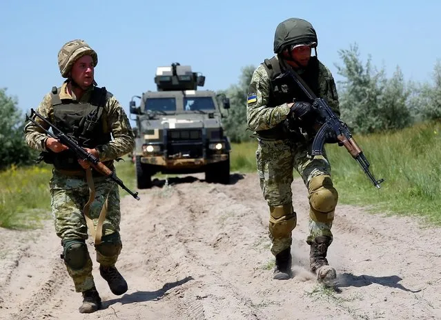 Ukrainian marines take part in a military exercises near Kherson, as Ukraine and the United States stage land military exercises involving more than 30 countries as part of multinational Sea Breeze 2021 drills in southern Ukraine, July 2, 2021. (Photo by Gleb Garanich/Reuters)