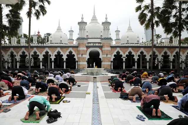Muslims practicing social distancing pray on the first Friday of Ramadan in Kuala Lumpur, Malaysia, April 16, 2021. (Photo by Lim Huey Teng/Reuters)