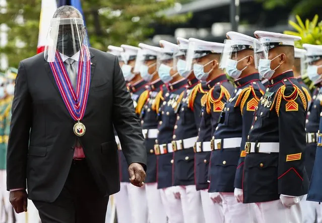 United States Defense Secretary Lloyd Austin views the military honor guard at Camp Aguinaldo military camp in Quezon City, Metro Manila, Philippines Friday, July 30, 2021. Austin is visiting Manila to hold talks with Philippine officials to boost defense ties and possibly discuss the The Visiting Forces Agreement between the US and Philippines. (Photo by Rolex dela Pena/Pool Photo via AP Photo)