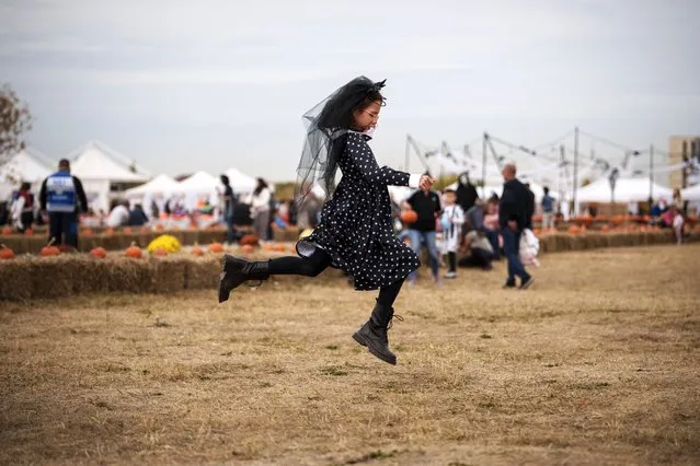 A girl plays at the West Side Hallo Fest, a Halloween festival in Bucharest, Romania, Friday, October 27, 2023. Tens of thousands streamed last weekend to Bucharest's Angels' Island peninsula for what was the biggest Halloween festival in the Eastern European nation since the fall of Communism. (Photo by Vadim Ghirda/AP Photo)