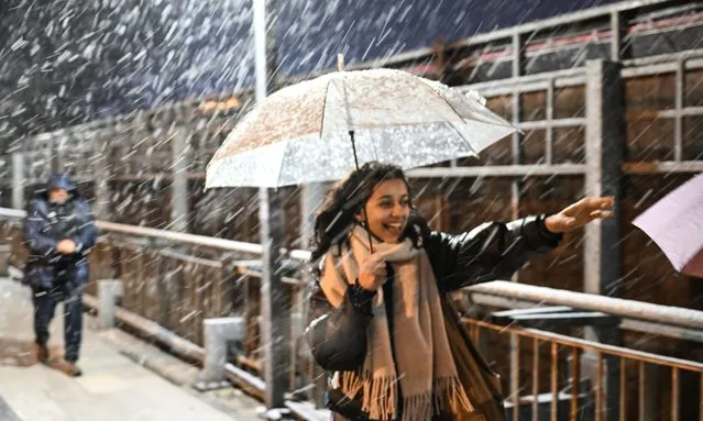 People walk with umbrella during snowfall in Istanbul, Turkiye on November 19, 2023. (Photo by Hakan Akgun/Anadolu via Getty Images)