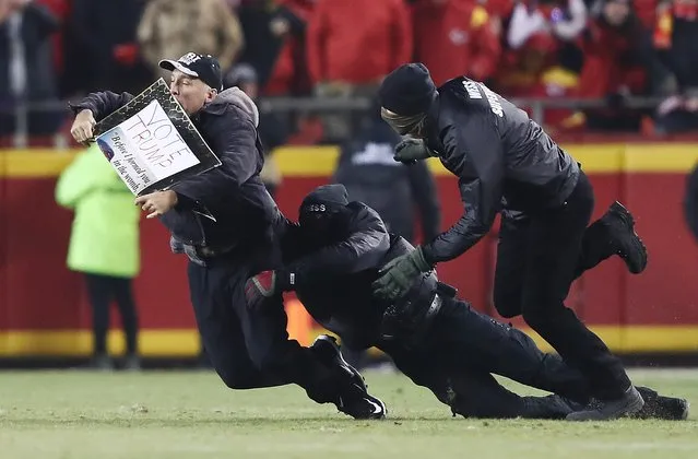 A protester is tackled by security after running on the field during the AFC Championship Game between the Kansas City Chiefs and the New England Patriots at Arrowhead Stadium on January 20, 2019 in Kansas City, Missouri. (Photo by Jamie Squire/Getty Images)