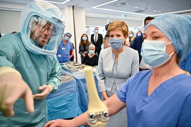 Scotland’s First Minister Nicola Sturgeon and Health Secretary Humza Yousaf visits a mock theatre set up with innovative new medical equipment including robotic surgery devices at the NHS Golden Jubilee on August 25, 2021 in Clydebank, Scotland. First Minister Nicola Sturgeon and Health Secretary Humza Yousaf launched the recovery plan during a visit to the new national Centre for Sustainable Delivery (CfSD) at the Golden Jubilee Hospital. (Photo by Jeff J. Mitchell/Pool via Getty Images)
