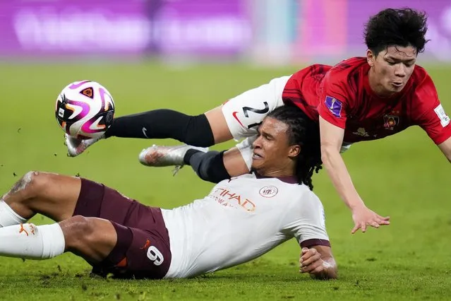 Manchester City's Nathan Ake vies for the ball with Urawa Reds' Tomoaki Okubo, right, during the Soccer Club World Cup semifinal soccer match between Urawa Reds and Manchester City FC at King Abdullah Sports City Stadium in Jeddah, Saudi Arabia, Tuesday, December 19, 2023. (Photo by Manu Fernandez/AP Photo)