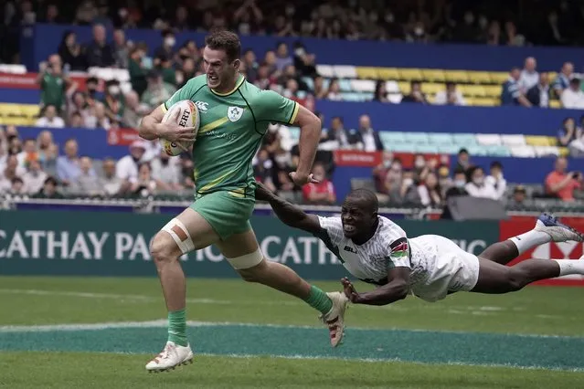 Jack Kelly of Ireland runs to score a try as Daniel Taabu of Kenya attempts to tackle him during the first day of the Hong Kong Sevens rugby tournament in Hong Kong, Friday November 4, 2022. The Hong Kong Sevens, a popular stop on the World Rugby Sevens Series circuit, is part of the government's drive to restore the city's image as a vibrant financial hub after it scrapped mandatory hotel quarantine for travelers. (Photo by Anthony Kwan/AP Photo)