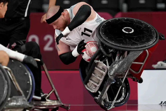 Mark Ingemann Peters of Denmark falls during a pool phase group match of Wheelchair Rugby at the Tokyo 2020 Paralympic Games, Thursday, August 26, 2021, in Tokyo, Japan. Each athlete has unique differences that have to be classified according to individual impairments. (Photo by Shuji Kajiyama/AP Photo)