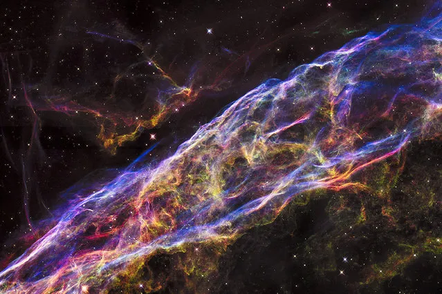 A small section of the expanding remains of the Veil Nebula, a massive star that exploded about 8,000 years ago. The entire nebula is 110 light-years across, covering six full moons on the sky as seen from Earth, and resides about 2,100 light-years away in the constellation Cygnus, the Swan. (Photo by Reuters/NASA/ESA/Hubble)