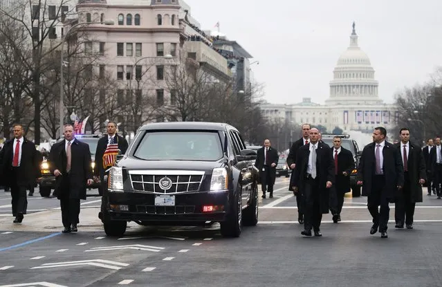 Secret Service agents walk alongside of U.S. President  Donald Trump's limousine as he participates in the inaugural parade after his swearing in at the Capitol in Washington, U.S., January 20, 2017. (Photo by Jonathan Ernst/Reuters)