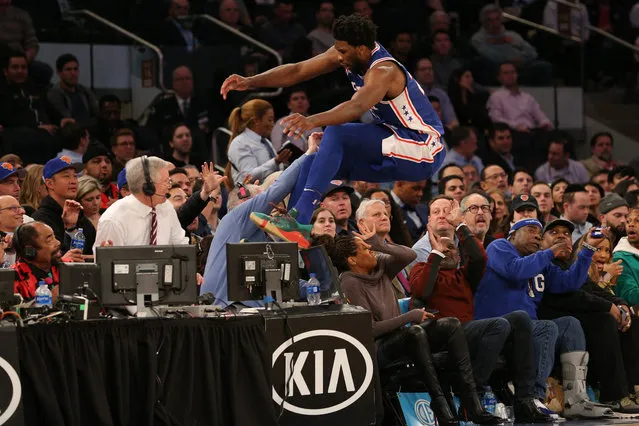 Philadelphia 76ers center Joel Embiid saves a ball from going out of bounds by jumping over actress Regina King during the third quarter against the New York Knicks at Madison Square Garden on February 14, 2019. (Photo by Brad Penner/USA TODAY Sports via Reuters)