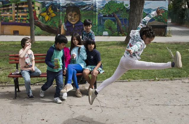 In this December 11, 2018 photo, Violeta, a transgender girl, jumps during recess at the Amaranta Gomez school in Santiago, Chile. Students agreed that the school has helped them fully embrace their identity. (Photo by Esteban Felix/AP Photo)