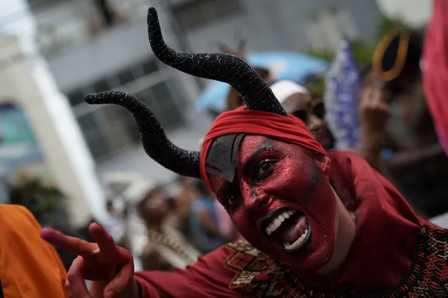 A reveler in a costume poses for the picture during the Carmelitas street party in Rio de Janeiro, Brazil, Friday, March 1, 2019. Much of the appeal of Rio street parties is the variety of themes and that people can dress up in costumes or not. (Photo by Leo Correa/AP Photo)