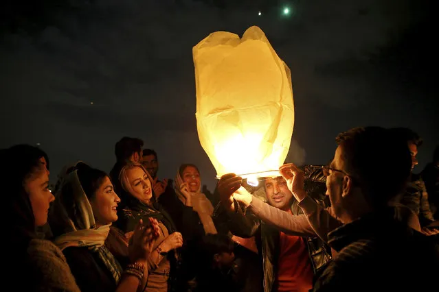Iranians release a lit lantern during a celebration, known as “Chaharshanbe Souri”, or Wednesday Feast, marking the eve of the last Wednesday of the solar Persian year, Tuesday, March 19, 2019, in Tehran, Iran. (Photo by Ebrahim Noroozi/AP Photo)