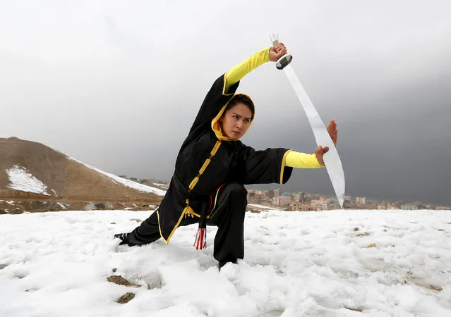 Sima Azimi, 20, a trainer at the Shaolin Wushu club, shows her Wushu skills to other students on a hilltop in Kabul, Afghanistan January 29, 2017. (Photo by Mohammad Ismail/Reuters)