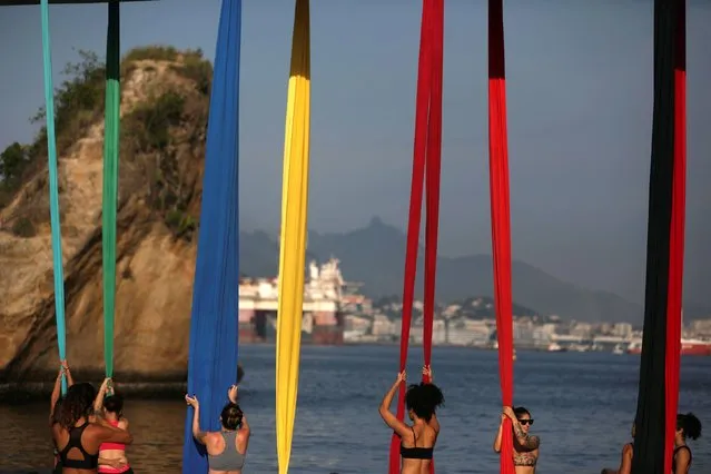 Women attend an aerial silk class at the Boa Viagem (Good Trip) beach in Niteroi, Brazil on April 5, 2019. (Photo by Pilar Olivares/Reuters)