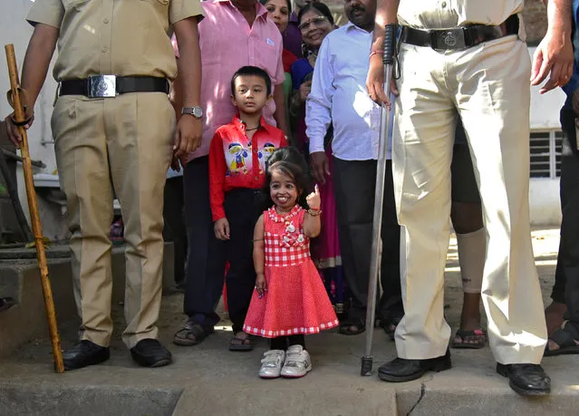 Jyoti Amge, 25, who holds the Guinness World Records title for the “Shortest Living Woman”, shows her ink-marked finger after casting her vote at a polling station during the first phase of the general election in Nagpur, India, April 11, 2019. (Photo by Reuters/Stringer)