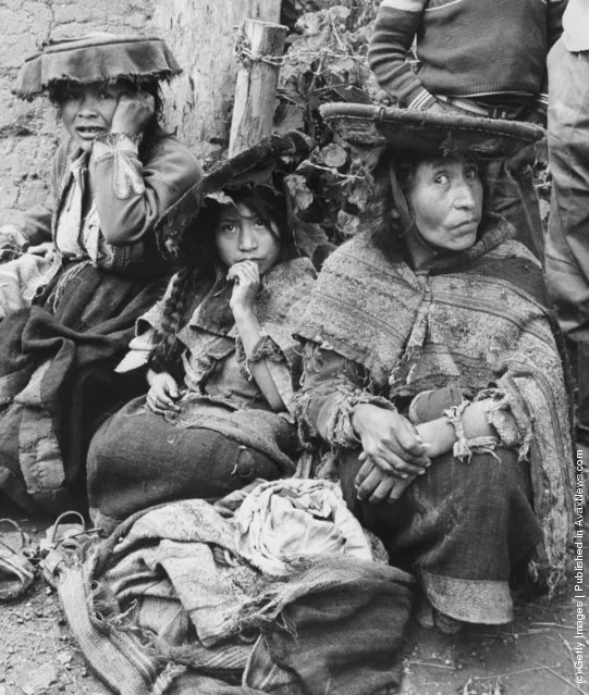 A Quechua woman hides her merchandise of coco leaves, at the market at Pisac, Peru, 1955