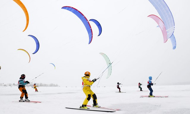Participants in the 2021 Siberia Snowkiting Cup held on the Berd Bay of the Novosibirsk Reservoir near the city of Novosibirsk, Russia on December 3, 2021. (Photo by Kirill Kukhmar/TASS)