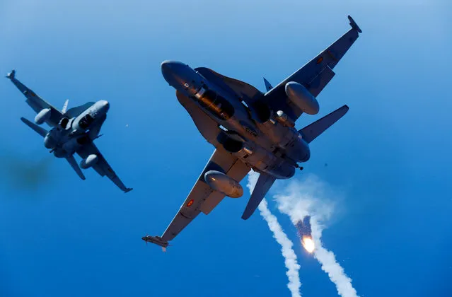 Two F-18 fighter aircrafts of the Spanish Air Force launch flares during the Ocean Sky 2021 Military Exercise for advanced air-to-air training in the southern airspace of the Canary Islands, Spain, October 21, 2021. (Photo by Borja Suarez/Reuters)