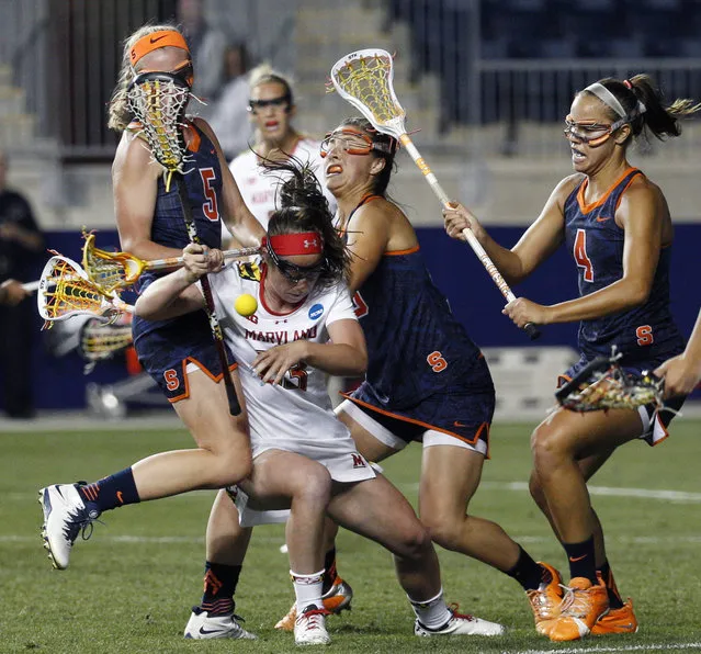 Maryland's attack Megan Whittle, center, gets squeezed by Syracuse's defender Haley McDonnell, left, and defender Mallory Vehar, right, during the second half of the semifinals in the NCAA Division I women's college lacrosse tournament, Friday, May 22, 2015, in Chester, Pa. Maryland won 10-8. (Photo by Chris Szagola/AP Photo)