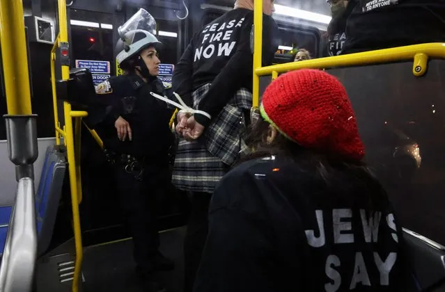 Police officers load detained protesters onto a bus during a protest demanding the U.S. government to stop arming Israel, during the ongoing conflict between Israel and the Palestinian Islamist group Hamas, in Brooklyn, New York City, April 23, 2024. (Photo by Jim Urquhart/Reuters)