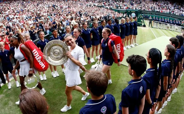 Simona Halep (C) of Romania celebrates with the trophy after winning against Serena Williams of the USA during their final match for the Wimbledon Championships at the All England Lawn Tennis Club, in London, Britain, 13 July 2019. (Photo by Nic Bothma/EPA/EFE/Rex Features/Shutterstock)
