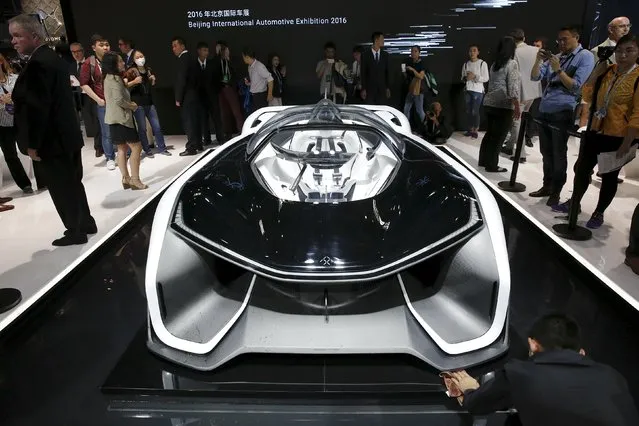 Visitors gather around the Faraday Future FFZERO1 electric concept car during the Auto China 2016 auto show in Beijing April 25, 2016. (Photo by Damir Sagolj/Reuters)