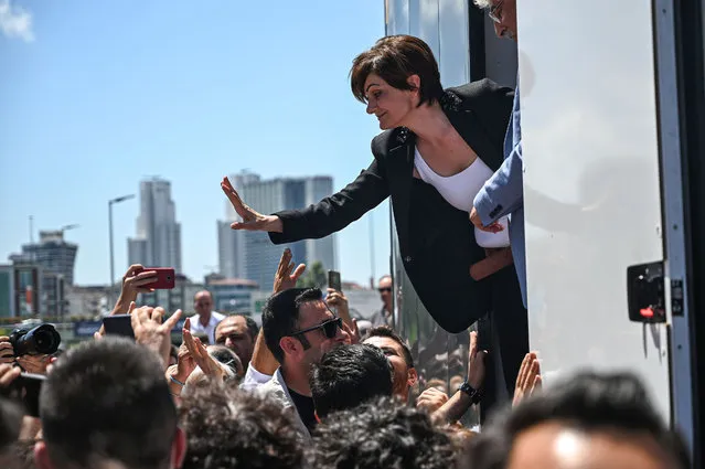 Republican People's Party (CHP) Istanbul chief Canan Kaftancioglu (R) waves to supporters as she stands on a stage to deliver a speech on July 18, 2019 after her trial in Istanbul. Kaftancioglu faces up to 17 years in prison for allegedly “insulting the Turkish President” in tweets posted between 2012 and 2017. The trial will resume on September 6, 2019. (Photo by Ozan Kose/AFP Photo)