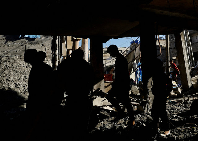 Palestinians inspect the site of an Israeli strike on a house, amid the ongoing conflict between Israel and the Palestinian Islamist group Hamas, in Rafah, in the southern Gaza Strip on April 17, 2024. (Photo by Mohammed Salem/Reuters)