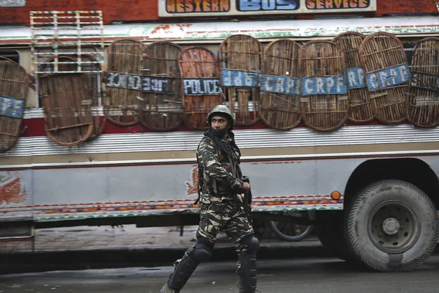An Indian paramilitary soldier patrols a street in Srinagar, Indian controlled Kashmir, Saturday, August 10, 2019. Authorities enforcing a strict curfew in Indian-administered Kashmir will bring in trucks of essential supplies for an Islamic festival next week, as the divided Himalayan region remained in a lockdown following India's decision to strip it of its constitutional autonomy. The indefinite 24-hour curfew was briefly eased on Friday for weekly Muslim prayers in some parts of Srinagar, the region's main city, but thousands of residents are still forced to stay indoors with shops and most health clinics closed. All communications and the internet remain cut off. (Photo by Mukhtar Khan/AP Photo)