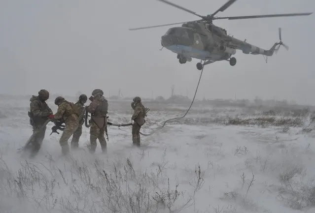 Service members of the Ukrainian Armed Forces take part in military drills in the Kherson region, Ukraine, in this handout picture released February 10, 2022. (Photo by Ukrainian Armed Forces Press Service/Handout via Reuters)