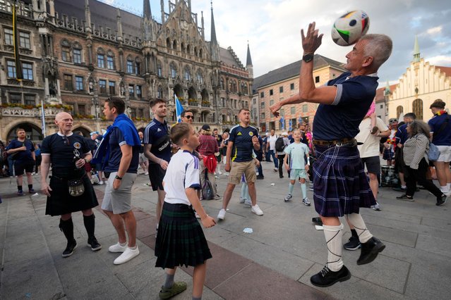 Scotland's soccer fans party at the “Marienplatz” square next to the town hall in downtown, Munich , Germany, Thursday, June 13, 2024. The Euro 2024 soccer tournament takes place in Germany from June 14 until July 14. (Photo by Antonio Calanni/AP Photo)