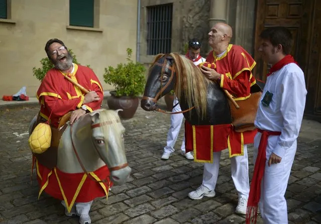 “Zaldikos” (men wearing horse figures) joke with each other in San Fermin festival's “Comparsa de gigantes y cabezudos” (Parade of the Giants and the Big Heads) in Pamplona, northern Spain, July 8, 2015. (Photo by Vincent West/Reuters)