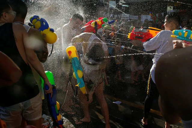 Revellers react during a water fight at Songkran Festival celebrations in Bangkok, Thailand on April 13, 2017. (Photo by Jorge Silva/Reuters)