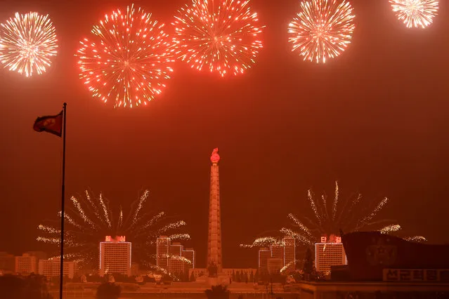 Juche Tower painted red during with fireworks at an evening patriotic program in Kim Il Sung Square in Pyongyang, North Korea on May 10, 2016. The day was full of two patriotic parades marking the culmination of the Seventh Congress of the Workers' Party which ended yesterday.   The Party cemented Kim Jong Un's leadership and yesterday named him as Party Chairman. He attended today's dayside parade waving from a balcony to a roaring crowd of worshipers.   This evening, a dance and torch parade complete with fireworks and 40,000 people dancing in uniform movement. (Photo by Linda Davidson/The Washington Post)