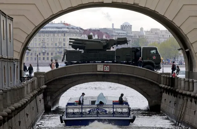 A Russian military vehicle is seen crossing a bridge on its way to a Victory Day parade rehearsal on the Dvortsovaya (Palace) embankment in St. Petersburg, Russia, 05 May 2014. Russia annually on 09 May celebrates the victory of the then Red Army over Nazi Germany. (Photo by Anatoly Maltsev/EPA)