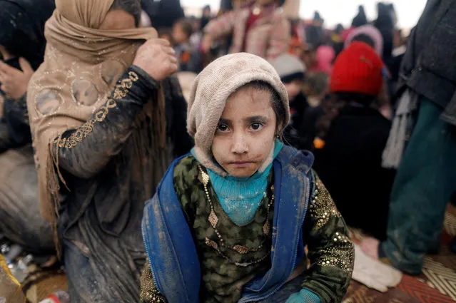 A displaced Iraqi girl who just fled her home sits at a processing center, as Iraqi forces battle with Islamic State militants in western Mosul, Iraq, March 4, 2017. (Photo by Zohra Bensemra/Reuters)