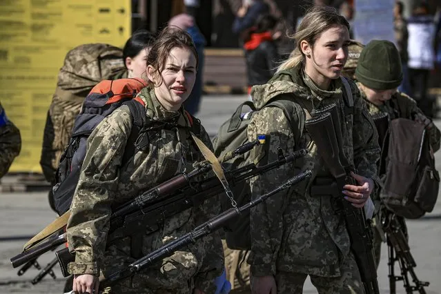 Ukrainian female soldiers are seen before heading to the frontline as Ukrainian displaced civilians continue to swarm around the train station to flee due to ongoing Russian attacks, in Lviv, Ukraine on March 24, 2022. (Photo by Metin Aktas/Anadolu Agency via Getty Images)