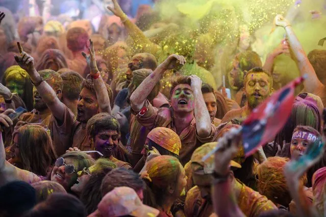 People gesture and dance as they take part in a color festival on May 19, 2016 at Besiktas in Istanbul. (Photo by Ozan Kose/AFP Photo)