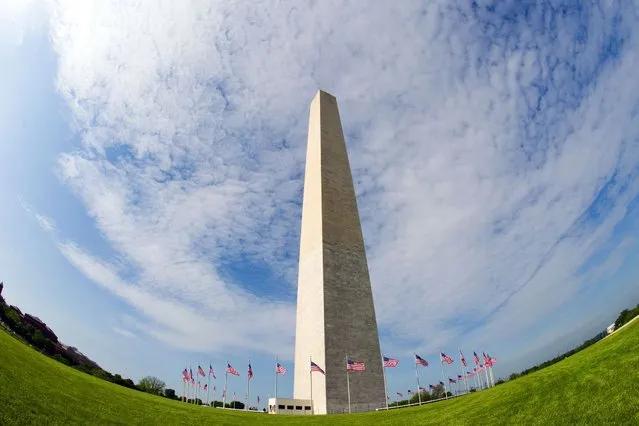 The Washington Monument is seen through a wide angle lens May 12, 2014 in Washington, DC. The Washington Monument, one of the US capital's most recognizable sights, is set to re-open Monday, three years after sustaining damage from a rare earthquake.The popular tourist attraction is the US capital city's tallest building at 555 feet (170-meters).(Photo by Karen Bleier/AFP Photo)