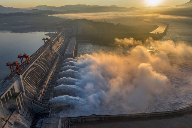 A spectacular view shows the opening of the Three Gorges Dam to release floodwater in Yichang, Hubei province, China, July 21, 2024. (Photo credit should read CFOTO/Future Publishing via Getty Images)