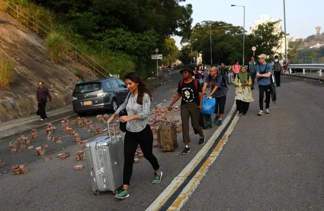 International students of the Chinese University of Hong Kong evacuate with their suitcases after anti-government protesters occupied the campus, in Hong Kong, China, November 15, 2019. (Photo by Athit Perawongmetha/Reuters)