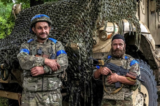 Ukrainian servicemen stand near an armoured personnel carrier, near the Russian border in Sumy region, Ukraine on August 13, 2024. (Photo by Viacheslav Ratynskyi/Reuters)