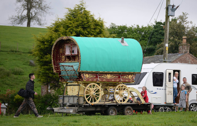 A decorated caravan during the Appleby Horse Fair on June 5, 2014 in Appleby, England. The Appleby Horse Fair has existed under the protection of a charter granted by James II since 1685 and is one of the key gathering points for the Romany, gypsy and traveling community. The fair is attended by about 5,000 travellers who come to buy and sell horses. The animals are washed and groomed before being ridden at high speed along the “mad mile” for the viewing of potential buyers. (Photo by Nigel Roddis/Getty Images)