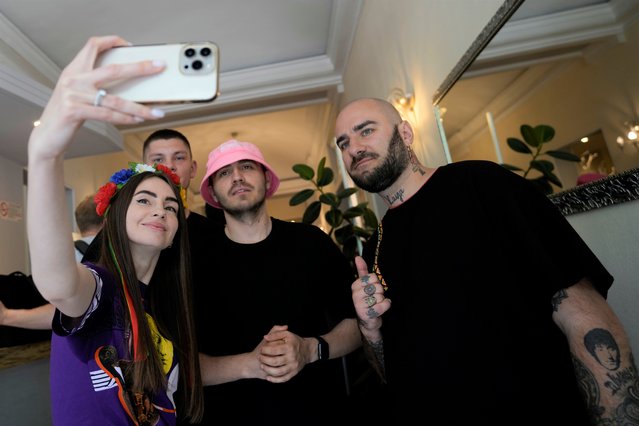 Oleh Psiuk, frontman of Ukraine's Kalush Orchestra and vocalist Sasha Tab, right, are pictured by a fan before leaving the Universo Hotel, after winning the Grand Final of the Eurovision Song Contest, in Turin, Italy, Sunday, May 15, 2022. (Photo by Luca Bruno/AP Photo)