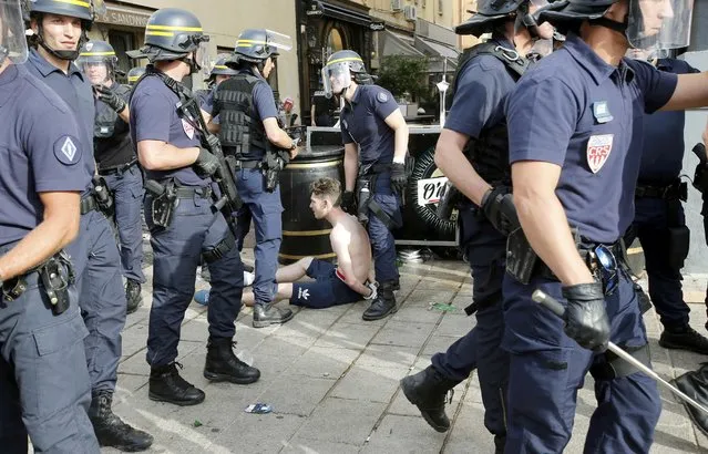 An England fan is detained by  riot police ahead of England's EURO 2016 match in Marseille, France, June 10, 2016. (Photo by Jean-Paul Pelissier/Reuters)