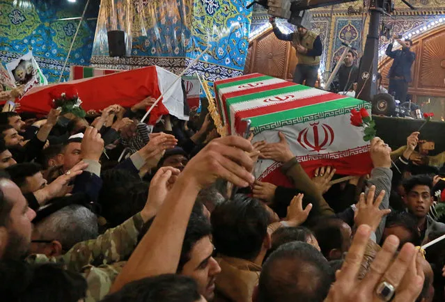 Mourners carry the coffins of Iran's top general Qassem Soleimani and Abu Mahdi al-Muhandis, deputy commander of Iran-backed militias in Iraq known as the Popular Mobilization Forces, during their funeral in the shrine of Imam Hussein in Karbala, Iraq, Saturday, January 4, 2020. Iran has vowed “harsh retaliation” for the U.S. airstrike near Baghdad's airport that killed Tehran's top general and the architect of its interventions across the Middle East, as tensions soared in the wake of the targeted killing. (Photo by Khalid Mohammed/AP Photo)