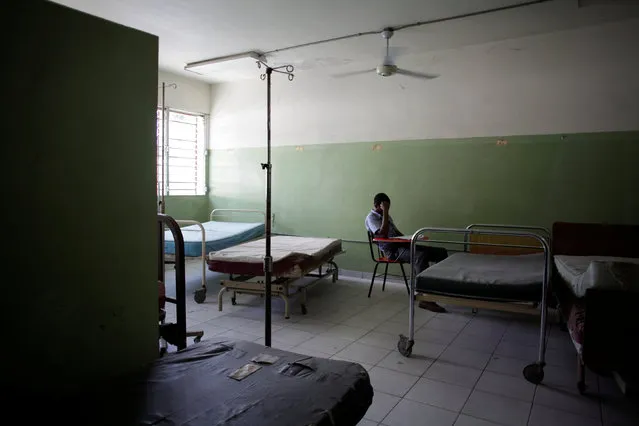 A student studies in an empty room at the Hospital of the State University of Haiti, which is one of the centers affected by a three-month-long strike by health workers demanding a pay rise and resources, in Port-au-Prince, Haiti, June 20, 2016. (Photo by Andres Martinez Casares/Reuters)