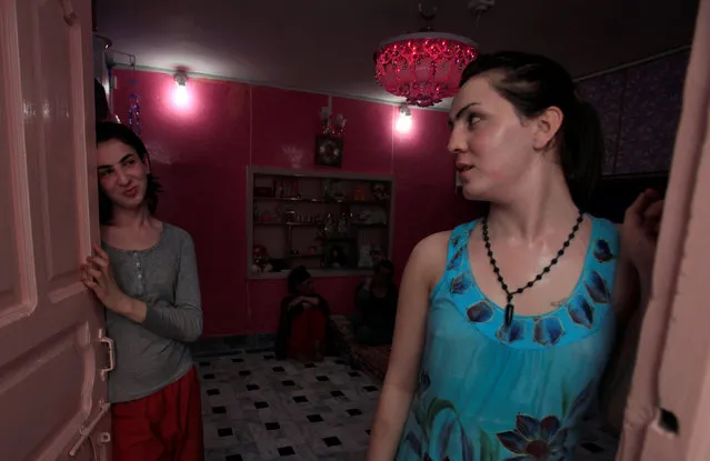 Transgenders Sunny (L) and Maria chat at the front door of their home in Peshawar, Pakistan June 27, 2016. (Photo by Fayaz Aziz/Reuters)